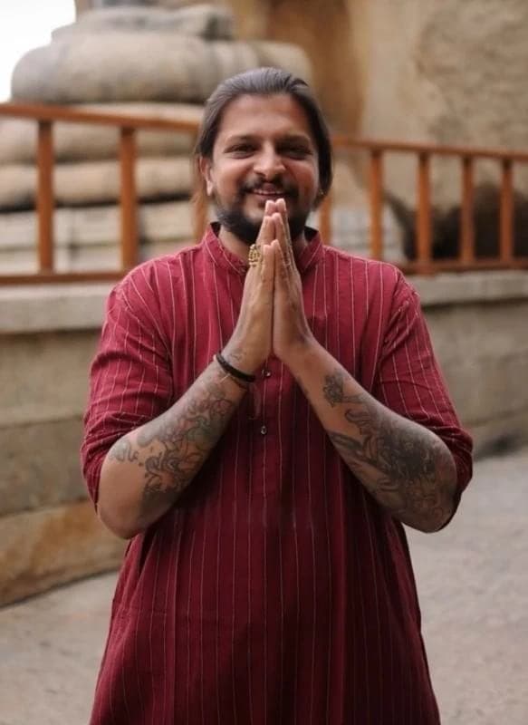 A member of the Adiveda family greeting with folded hands