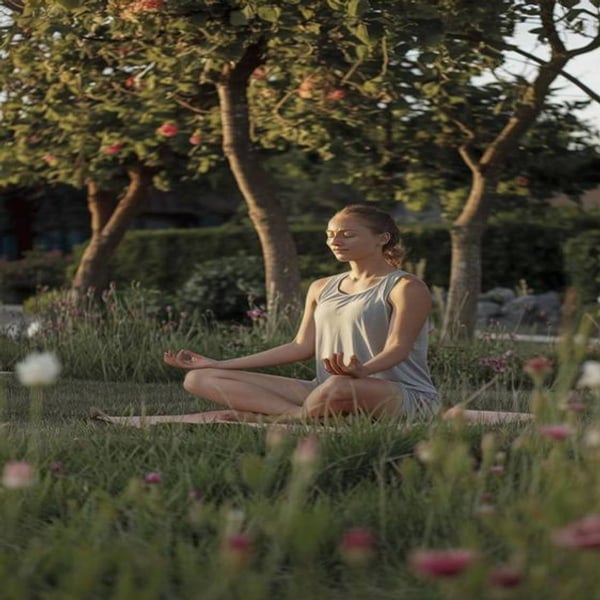 A woman meditating in a garden